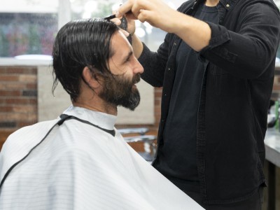 Trabajador cortando el pelo a un hombre